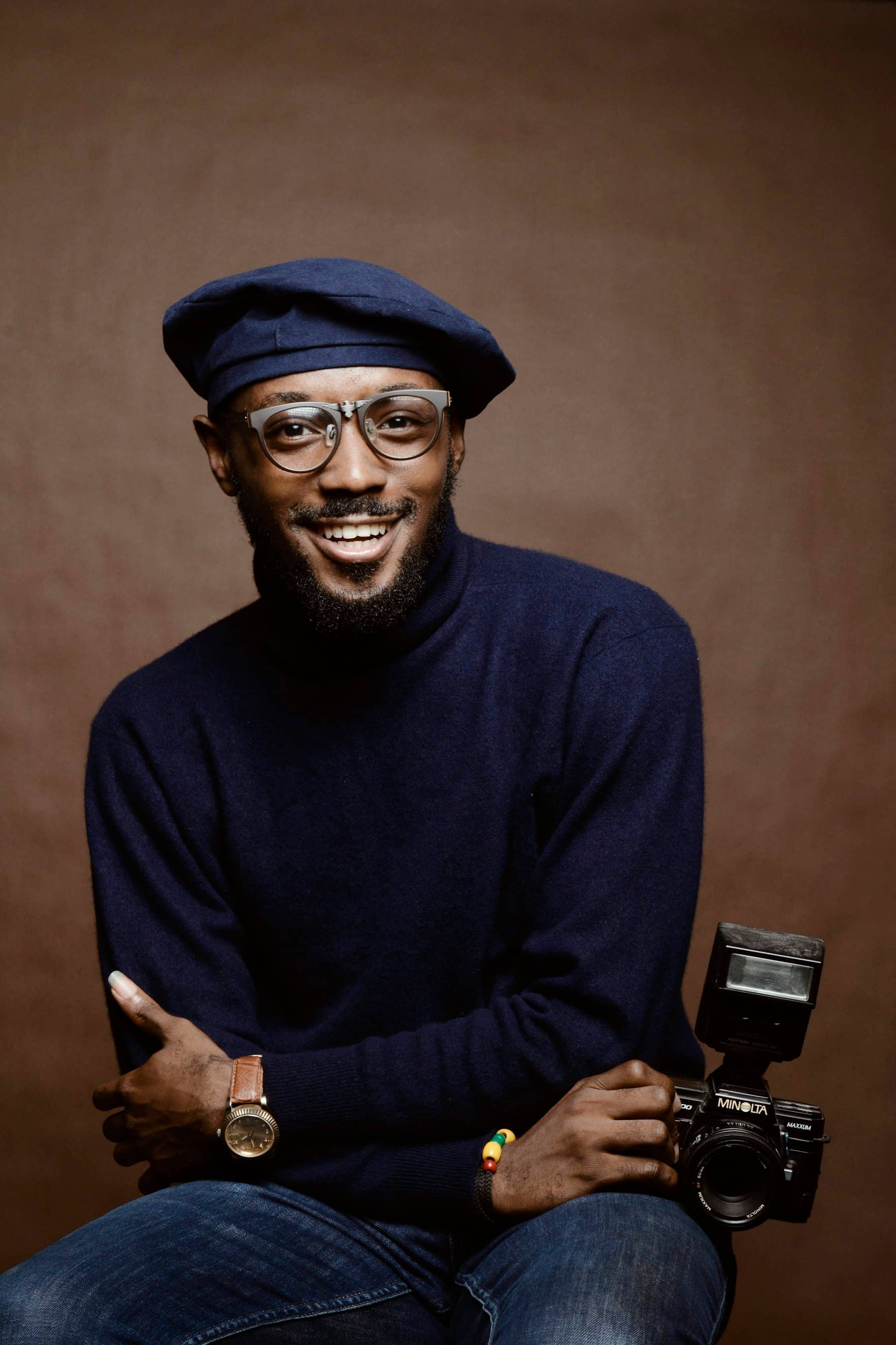 Creative with a camera, seated in a studio portrait